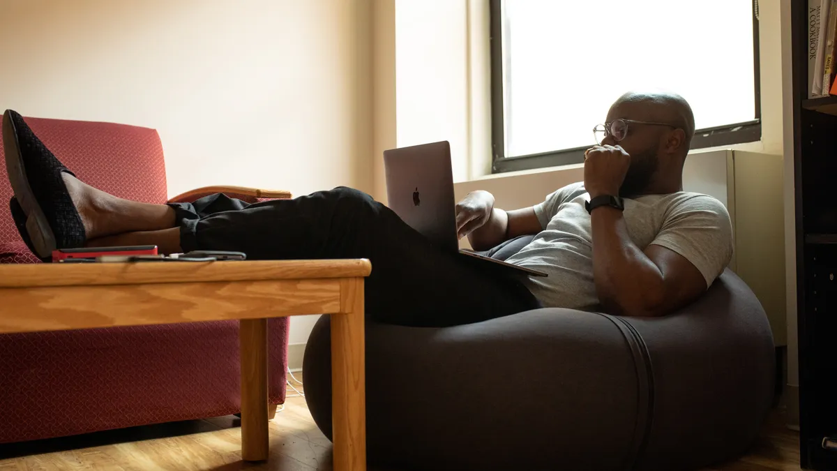 man working at home on a laptop