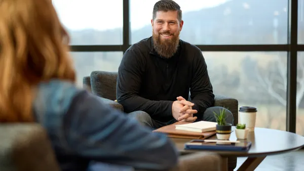 A man and a women having a meeting in a lounge.