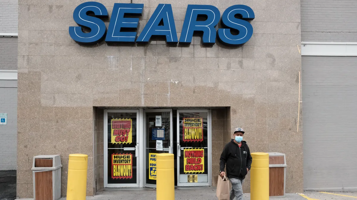 A person walks out of a Sears store stands on October 18, 2021 in the Flatbush neighborhood of Brooklyn borough in New York City.