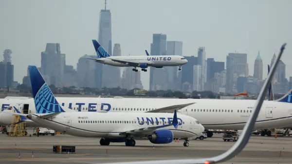 A United Airlines plane lands at Newark Liberty International Airport in front of the New York skyline on September 17, 2023 in Newark, New Jersey.