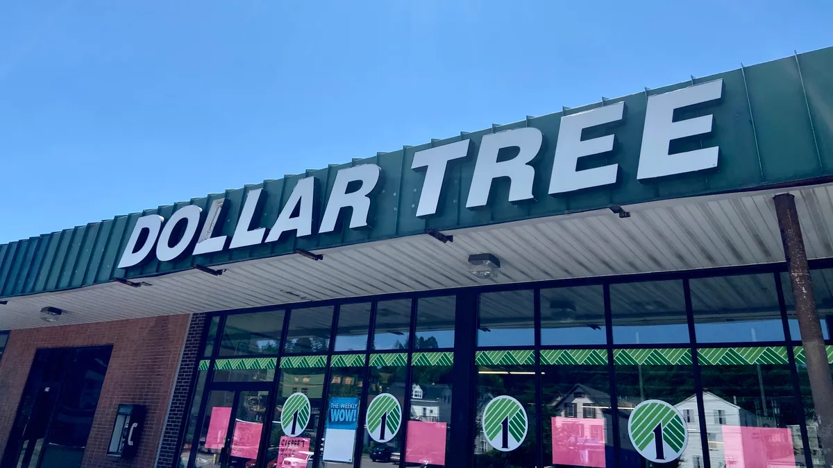 A green store banner says "Dollar Tree" against a hazy blue sky.