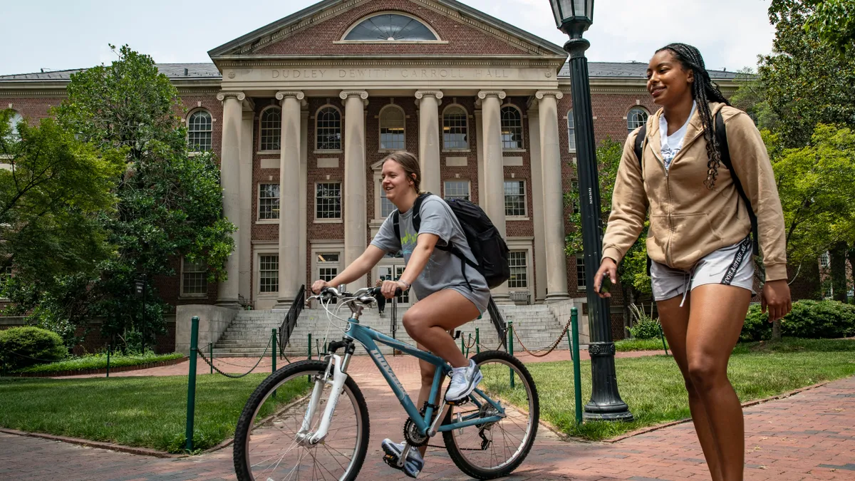 Two students walk on the campus of UNC-Chapel Hill.