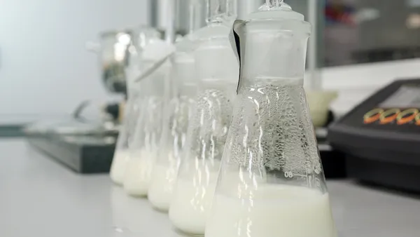 milk bottles being tested in a lab setting