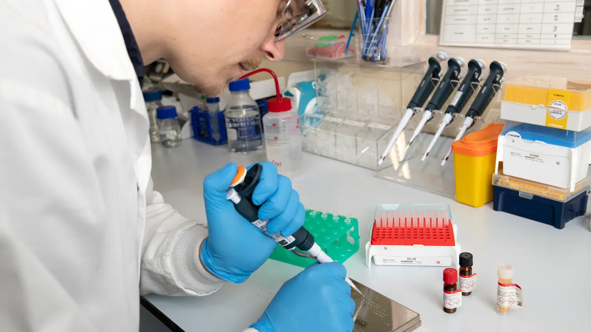 A chemist in the lab working on a chemical experiment