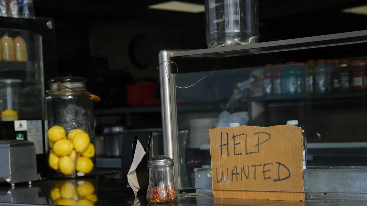 A help wanted sign is displayed at a boardwalk restaurant the day before the Memorial Day weekend, the unofficial start of summer, in the shore community of Wildwood on May 28, 2021 in Wildwood, New J