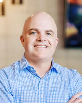 Man in blue shirt smiling