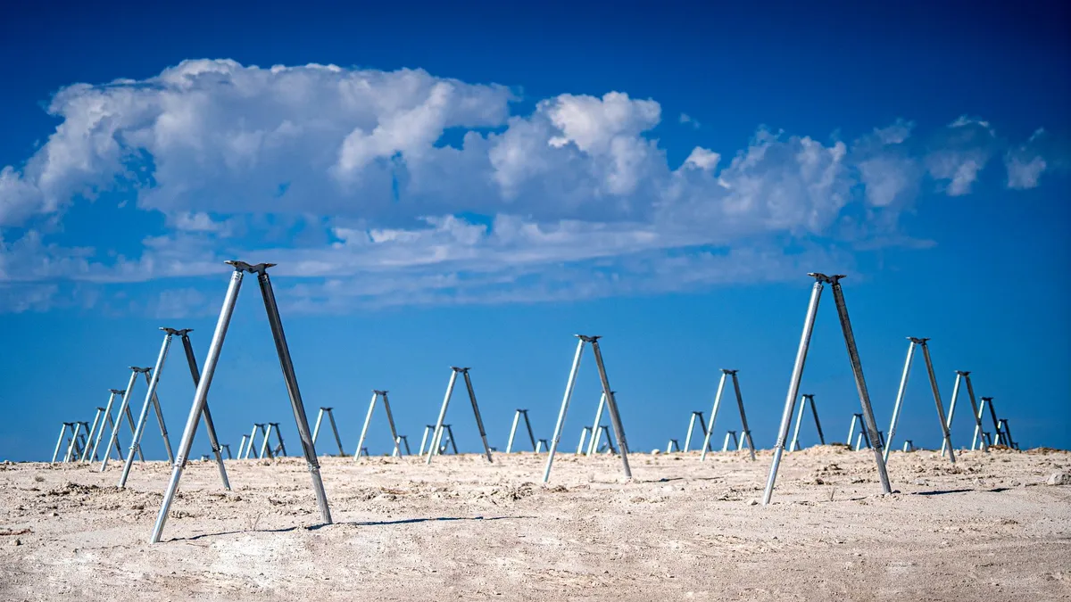 A bunch of poles on a plain land