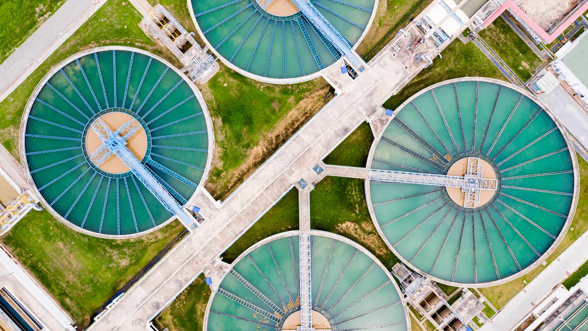 Circular clarifier tanks are seen at a water treatment facility