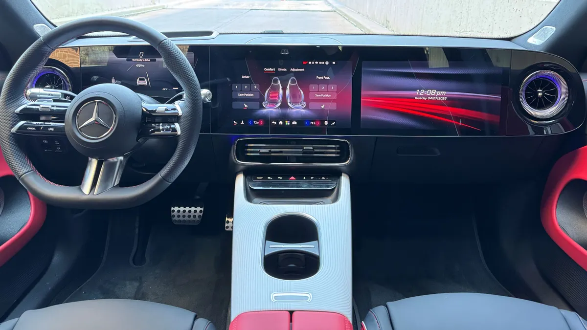 An eye-level shot of the Mercedes-Benz CLA 250+ electric's interior. Mercedes-Benz dazzles you in the CLA with bright, vibrant color, display screens that stretch across the entire dashboard, and welcoming sounds as you open the door to trigger emotions of purpose. Moreover, ambient light floods the cabin, not to a point of distraction, but to maximized satisfaction.
