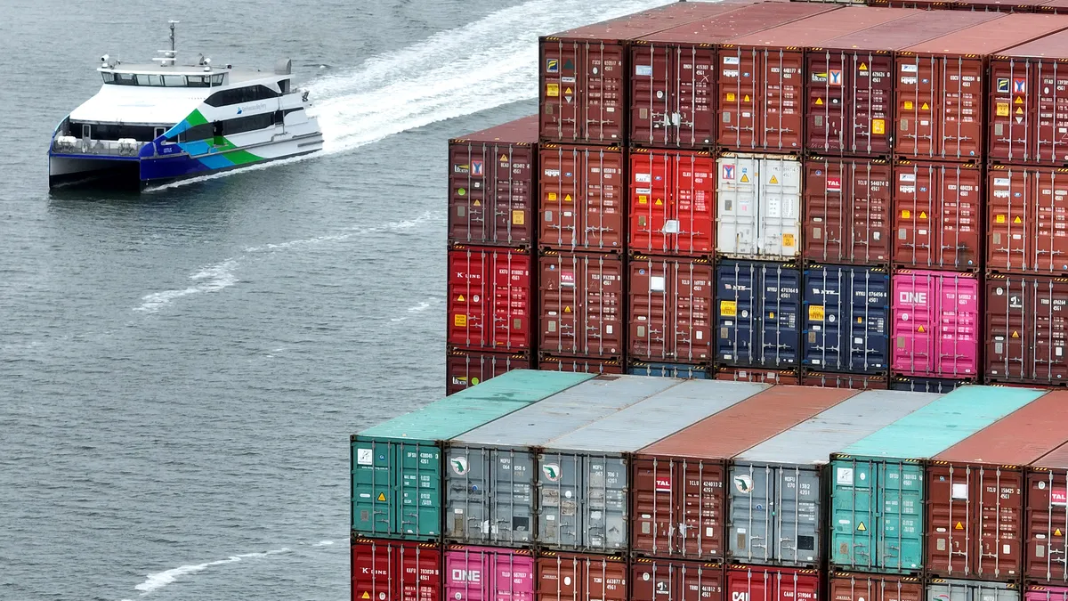 Shipping containers are seen stacked on a ship docked at the Port of Oakland.