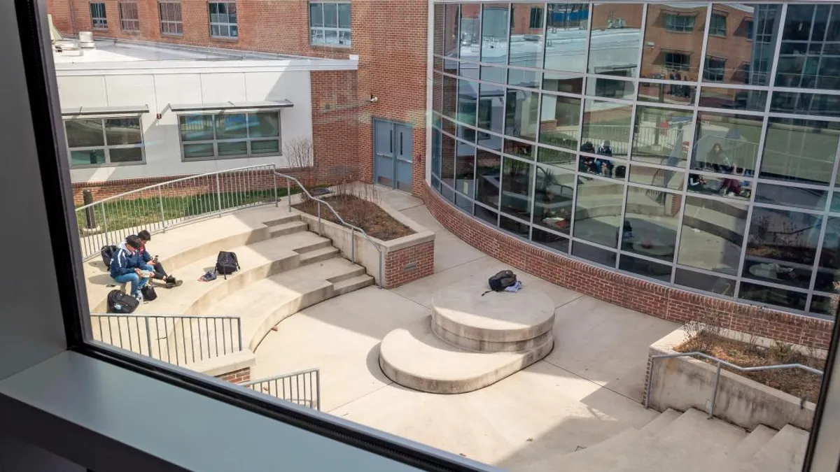 Students sit on Fairfax's Thomas Jefferson High School's campus