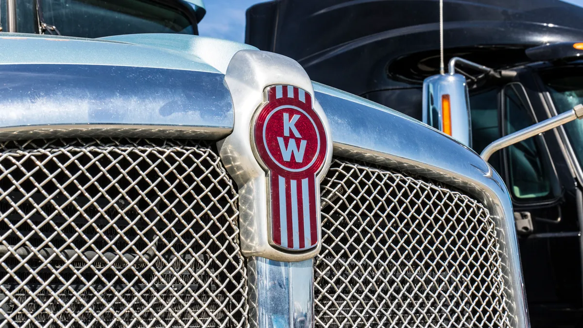 Two trucks, featuring a tractor with the Kenworth logo.