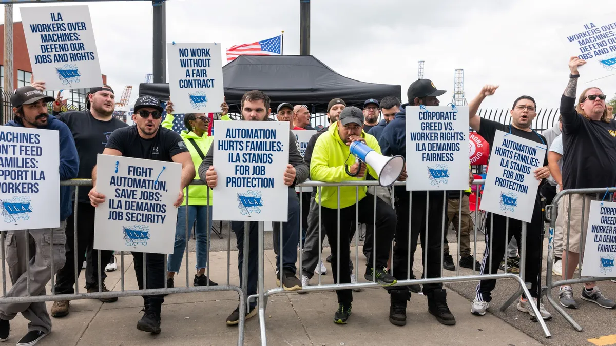 A group of dockworkers striking at an ocean terminal in Brooklyn, NY.