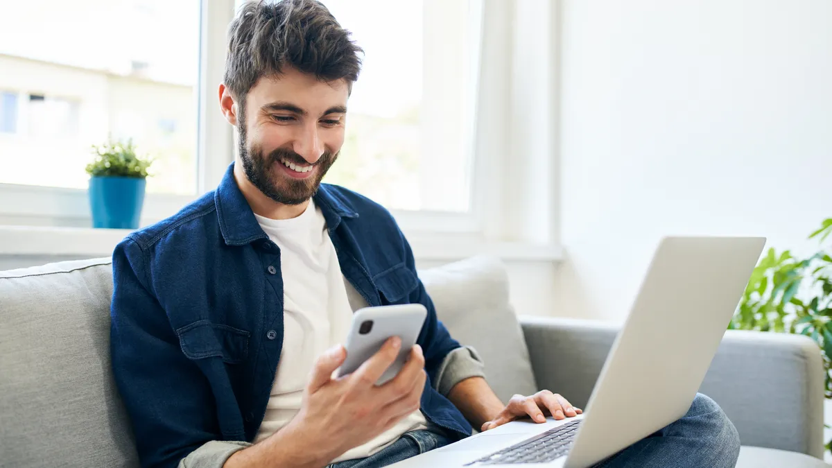 Person smiling looking at phone