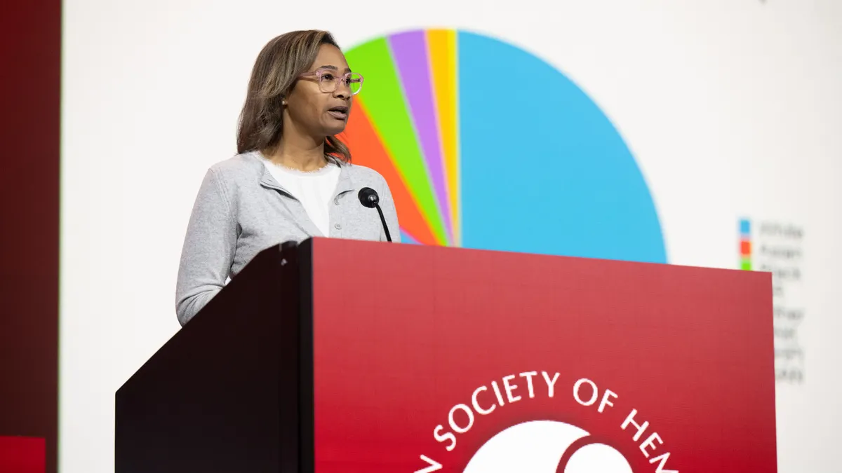 Nicole Gormley on stage at ASH23, presenting a data visualization from the FDA.