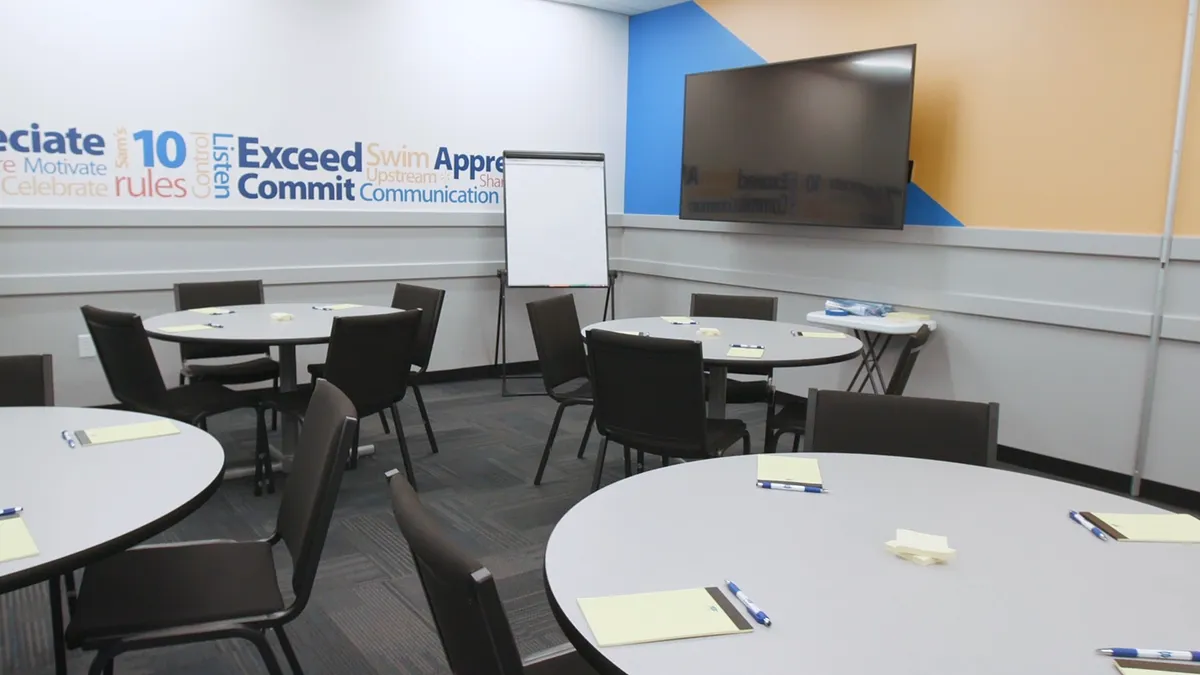 Tables set up for classes at a Walmart Academy in 2019.