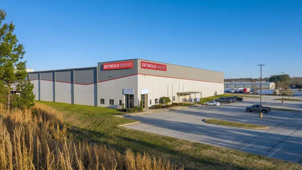 The exterior of a building with branding for Deltmold Group.