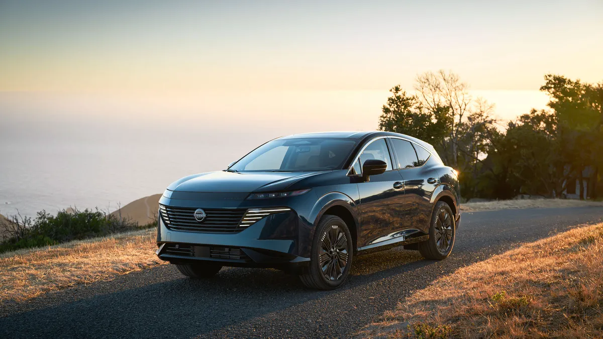 A 2025 Nissan Murano SUV parked on a hill overlooking a body of water.