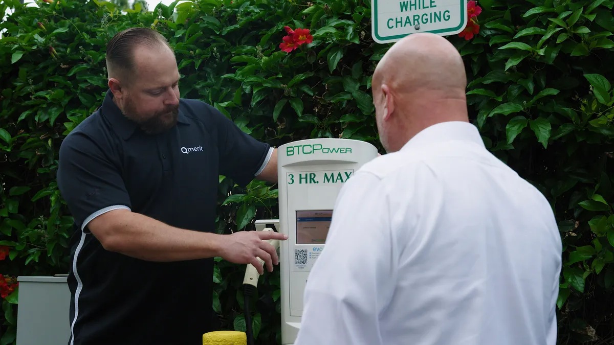 A Qmerit technician looks at a charging meter.