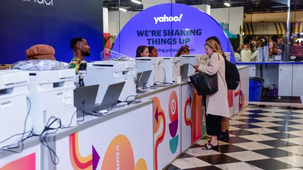 A person interacts with a registration desk at Advertising Week