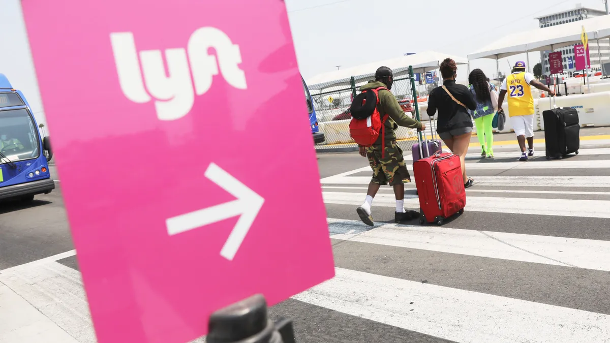 Air travelers walk toward a Lyft pickup area at Los Angeles International Airport (LAX) on August 20, 2020 in Los Angeles, California.