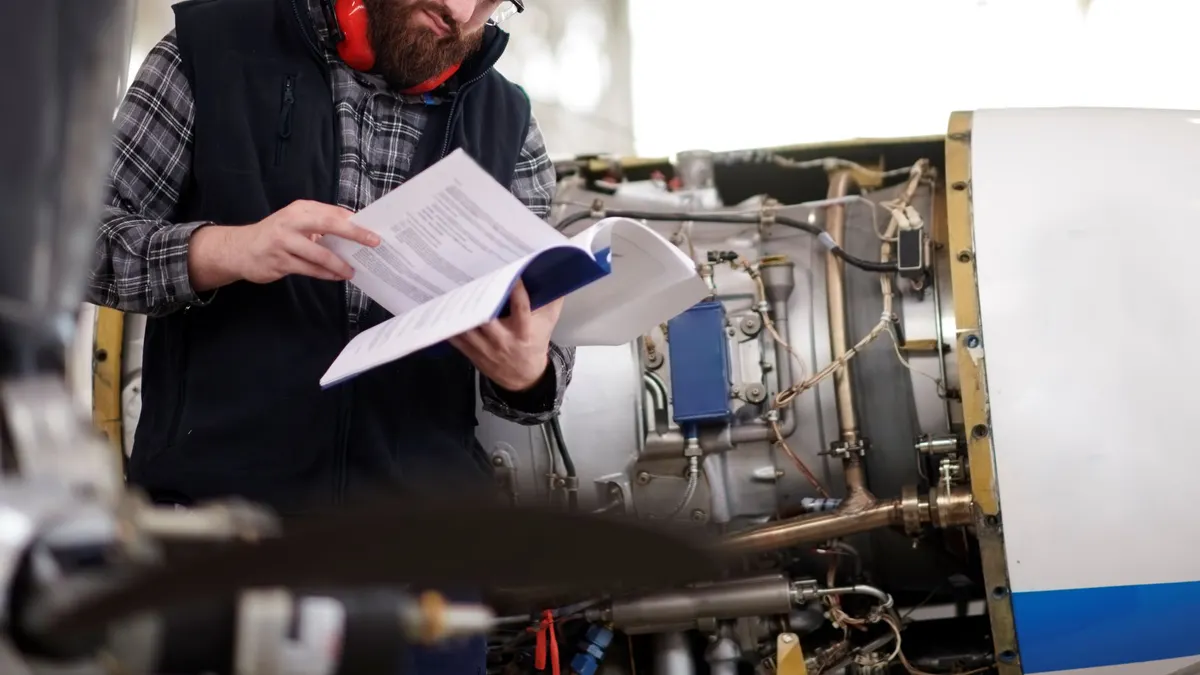 An individual reads a handbook