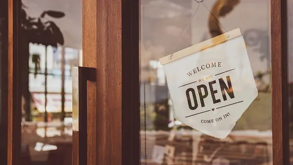 Welcome open sign in local café