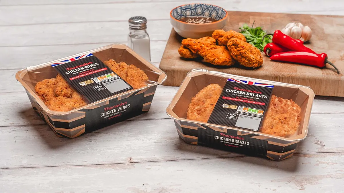 Paper containers with a film sealed cover hold pieces of fried chicken.