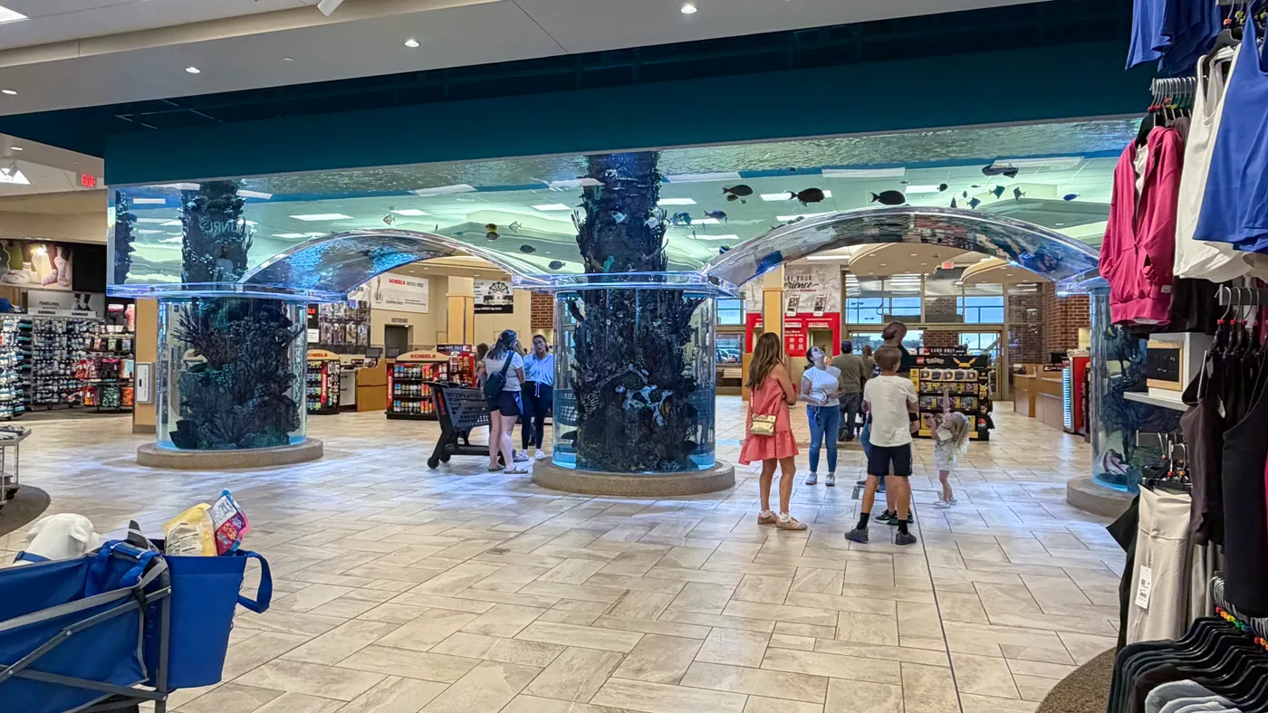 Shoppers pause at an acquarium tank inside a Scheels store in Colorado Springs, Colorado.