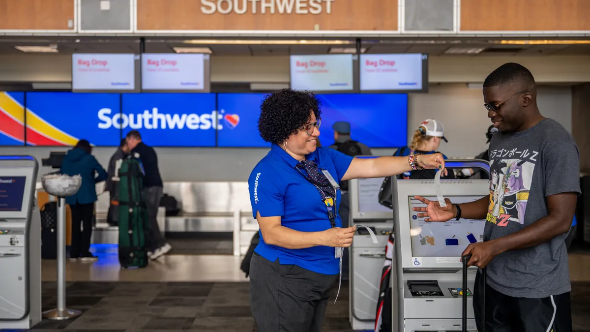 A Southwest Airlines employee assists a passenger.