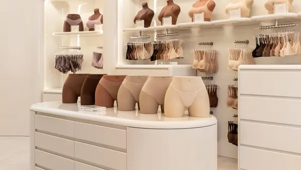 Underwear and bras on display in a white room.