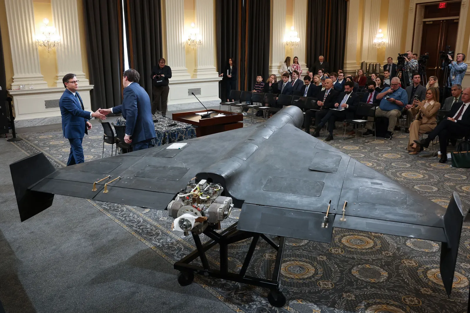 U.S. Speaker of the House Mike Johnson pictured next to an Iranian Shahed 136 military drone