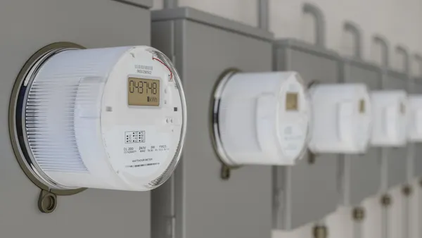 A row of electric utility meters on a wall.