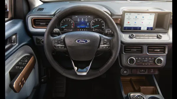 An interior photo showing the steering wheel and dashboard in a 2024 Ford Maverick pickup.