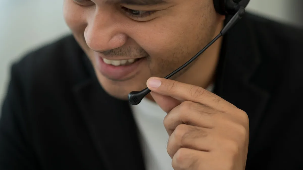 Person with a headset on talking to someone.