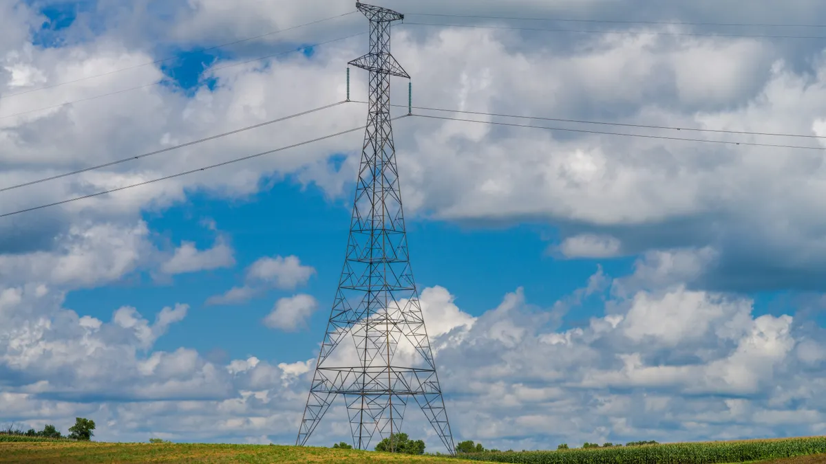Electric transmission lines run above a field.