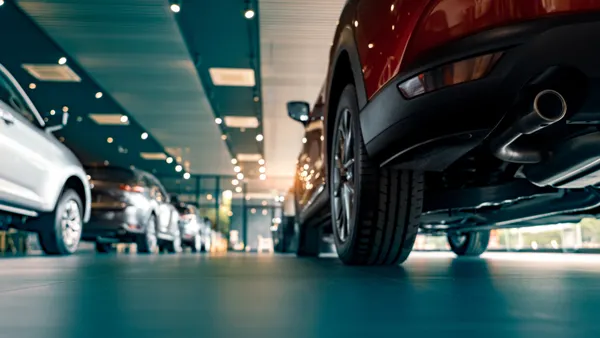Rearview of parked cars Car dealership office.