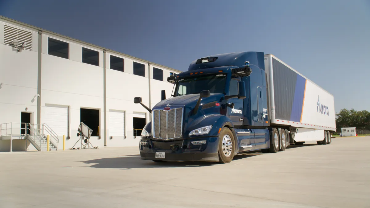 An Aurora autonomous truck and trailer outside the company's new Houston terminal.