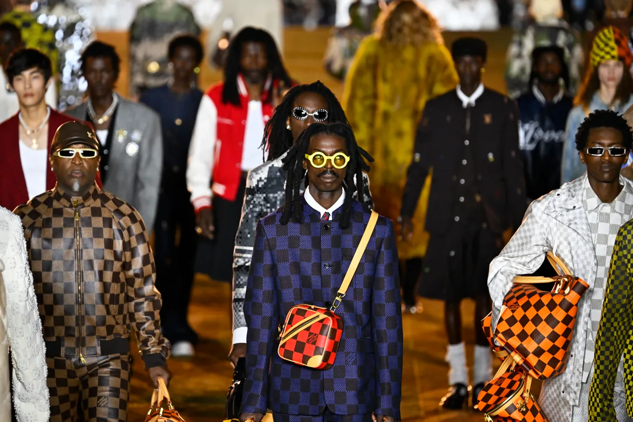 Models in colorful suits walk the runway during the Louis Vuitton Menswear Spring/Summer 2024 show.