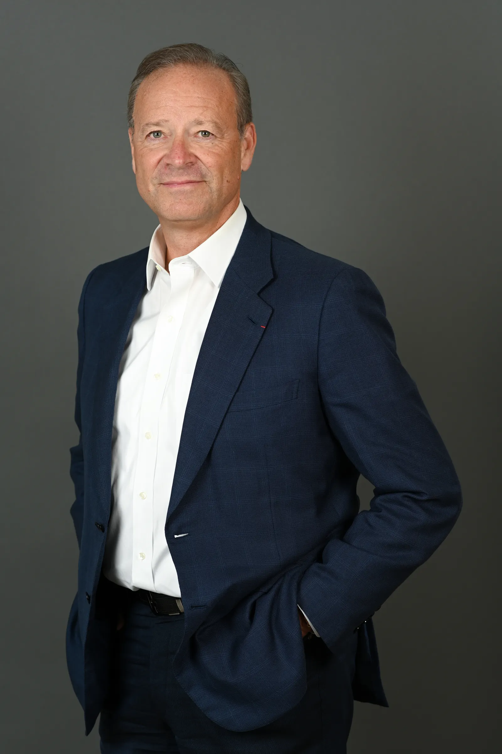 A man in a suit looking at the camera