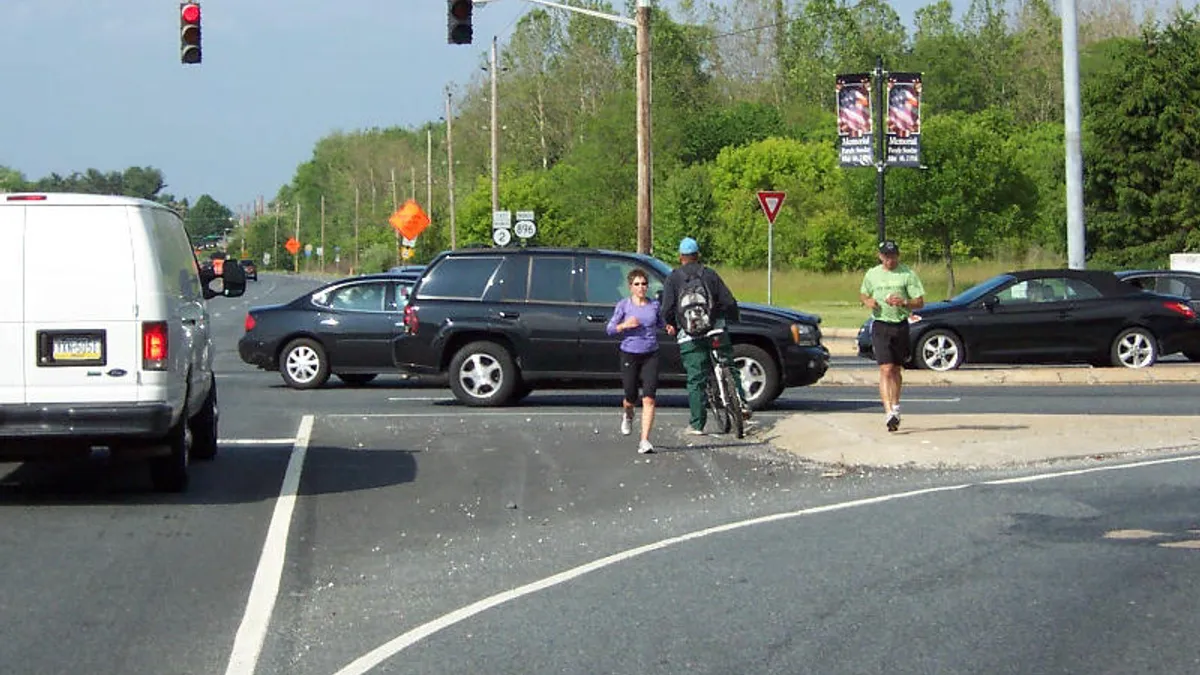 Pedestrian and cyclist at intersection