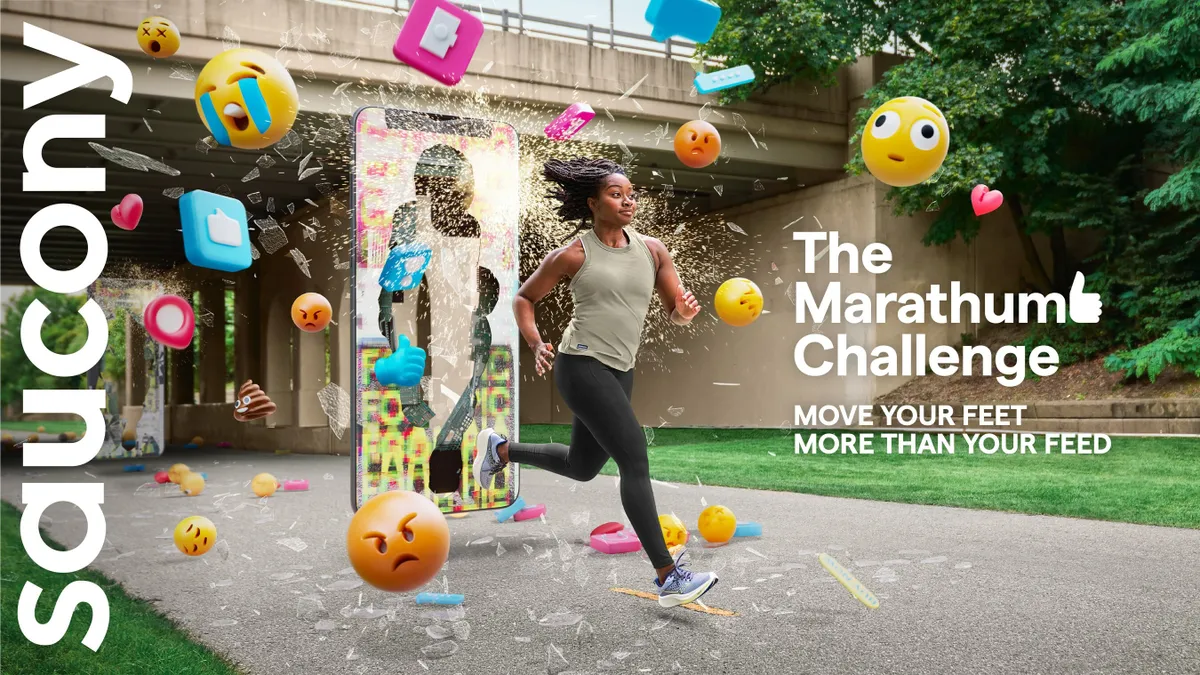 A person wearing athletic clothing and running shoes runs throughs a phone screen as glass and emoji's burst out.