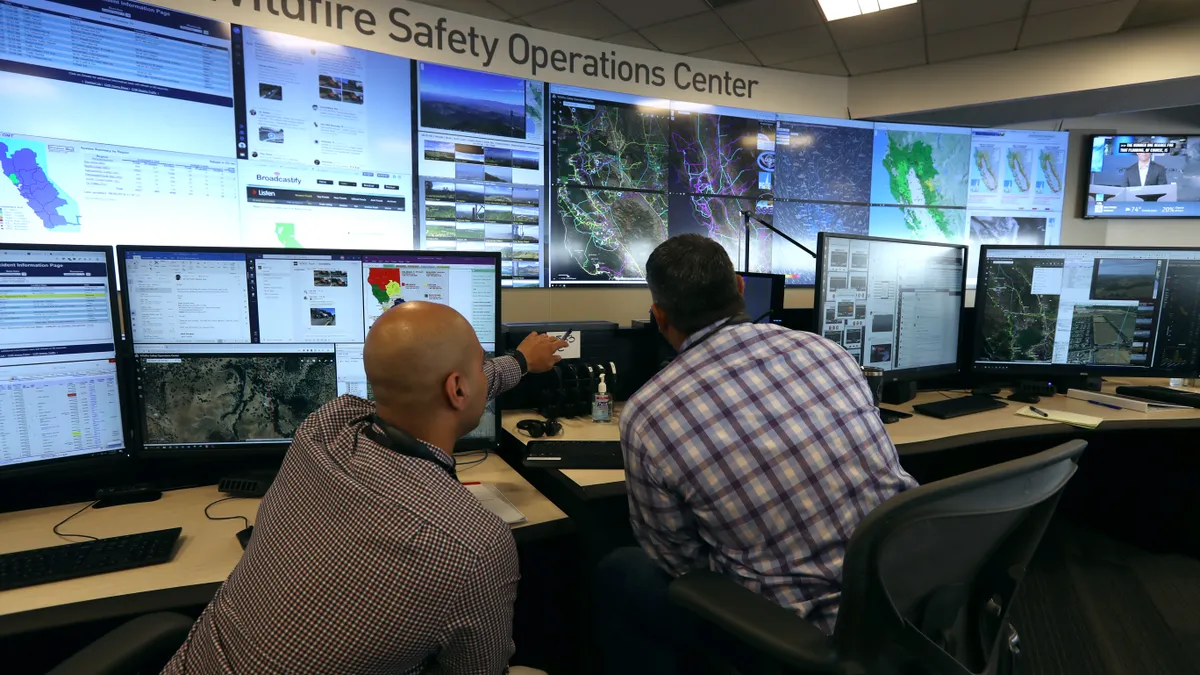 Analysts at the Pacific Gas and Electric (PG&E) Wildfire Safety Operations Center monitor a wildfire on August 05, 2019 in San Francisco, California.