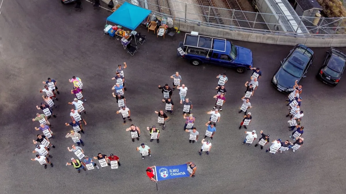 ILWU Local 500 members pose for an aerial photo at Port of Vancouver's Neptune Terminals on July 5, 2023, as part of ILWU Canada's strike.