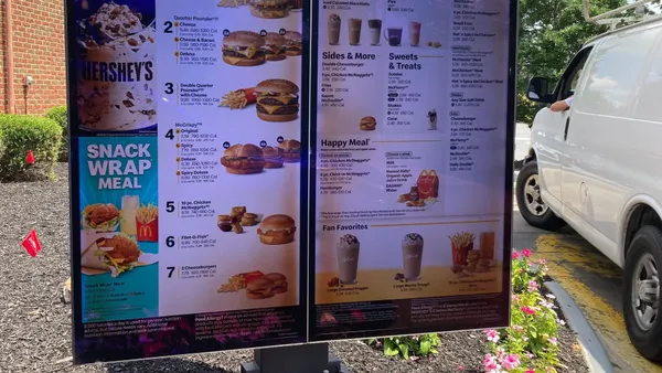 A photograph of a digital menu board at McDonald's with various meal options.