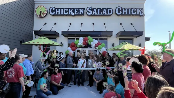 A fast casual restaurant with a celebratory crowd ready for its opening.