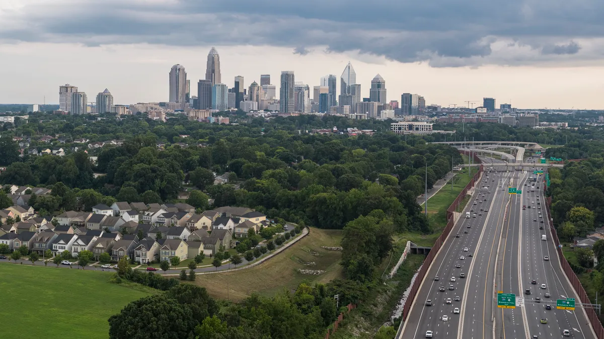 Interstate 77 with the traffic on it in the evening with downtown Charlotte, North Carolina, in the background.