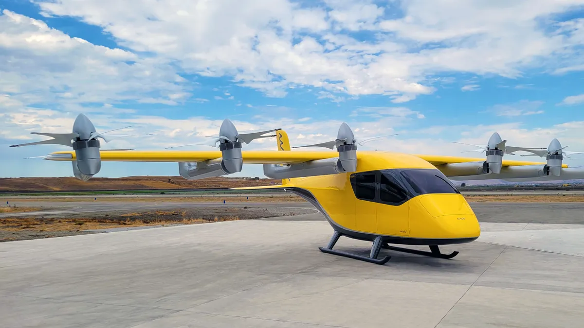 A futuristic yellow electric takeoff and landing aircraft sits on the tarmac.