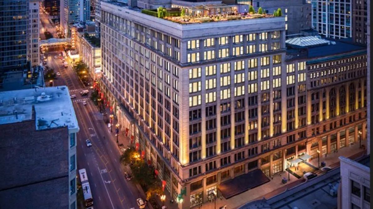 Lights are on at the Marshall Field & Co building in Chicago's Loop neighborhood at dusk.