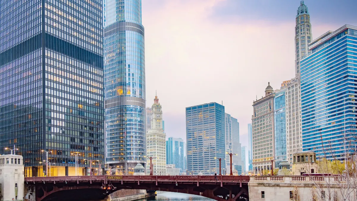 A cityscape of skyscrapers and commercial buildings around State Street Bridge in Chicago.